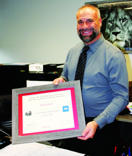 Local housing director completes education program